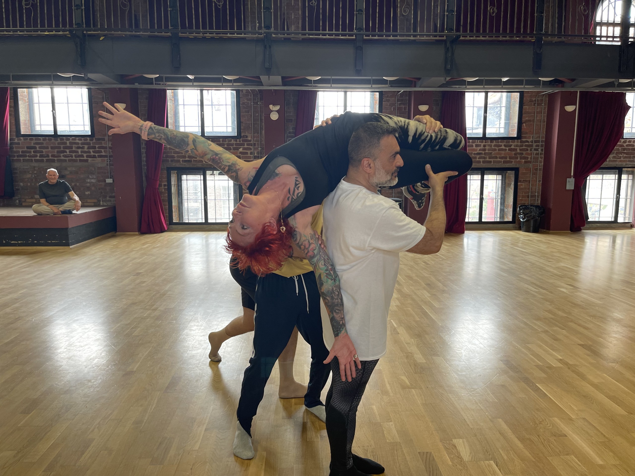 2 dancers at Fallen Angels Dance Theatre, one holding another in a lift