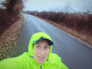 Ina Marathon runner for Fallen Angels Dance Theatre with waterproof coat on in the rain. 