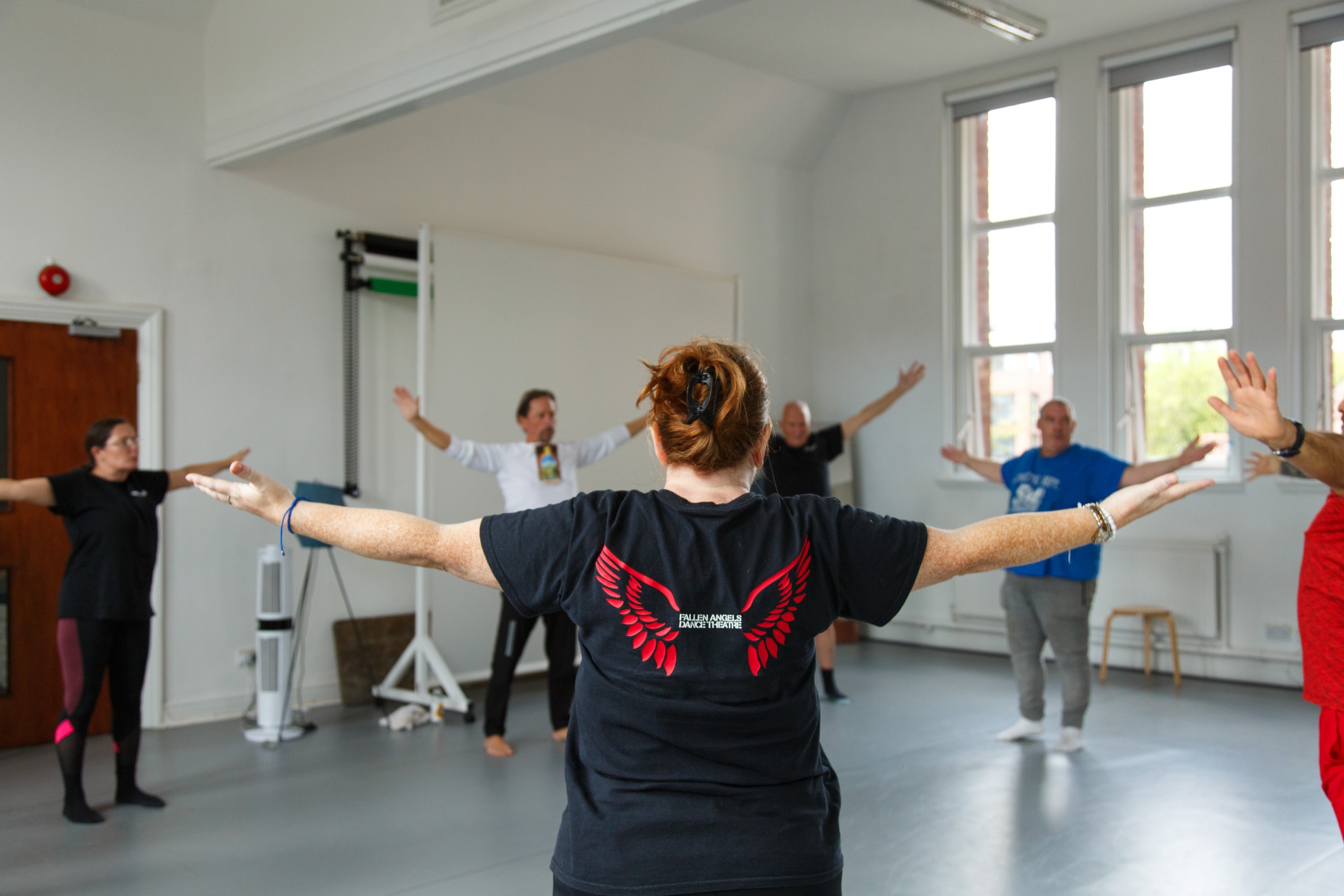 Participants doing a warm up at a Fallen Angels movement workshop